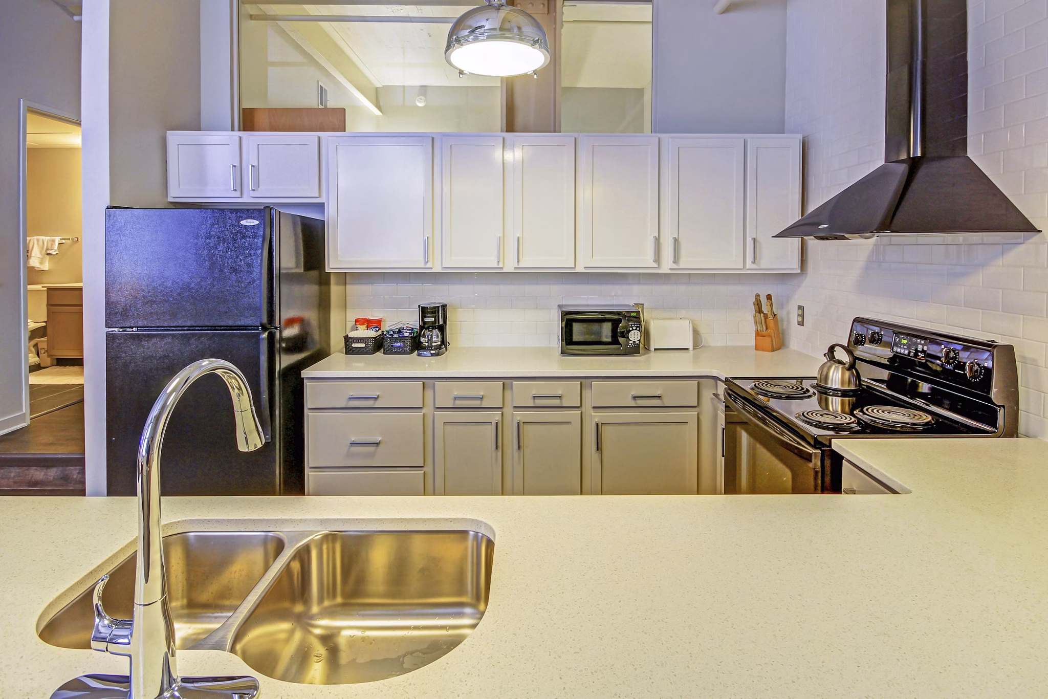 Modern kitchen with stainless steel appliances at Heinz Lofts Apartments, Greystar luxury apartments in urban setting
