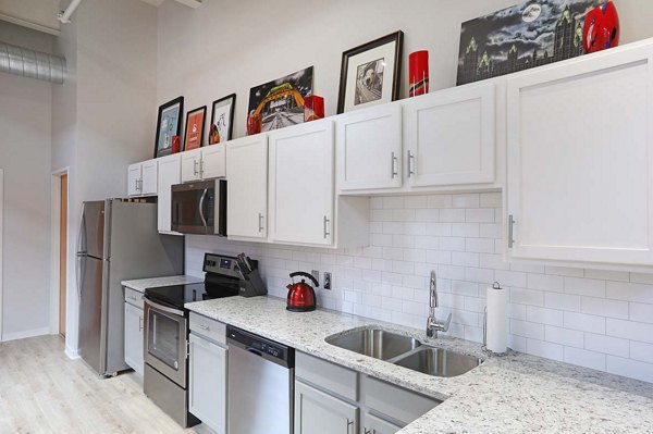 Kitchens with stainless steel appliances and granite countertops in Heinz Lofts Apartments