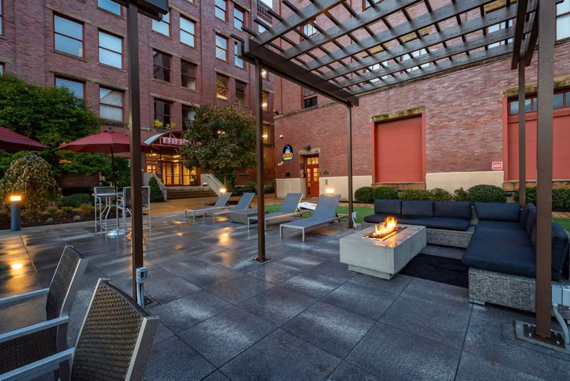Courtyard featuring landscaped gardens and seating areas at Heinz Lofts Apartments, luxury apartments by Greystar