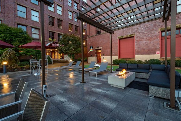 Courtyard featuring landscaped gardens and seating areas at Heinz Lofts Apartments, luxury apartments by Greystar