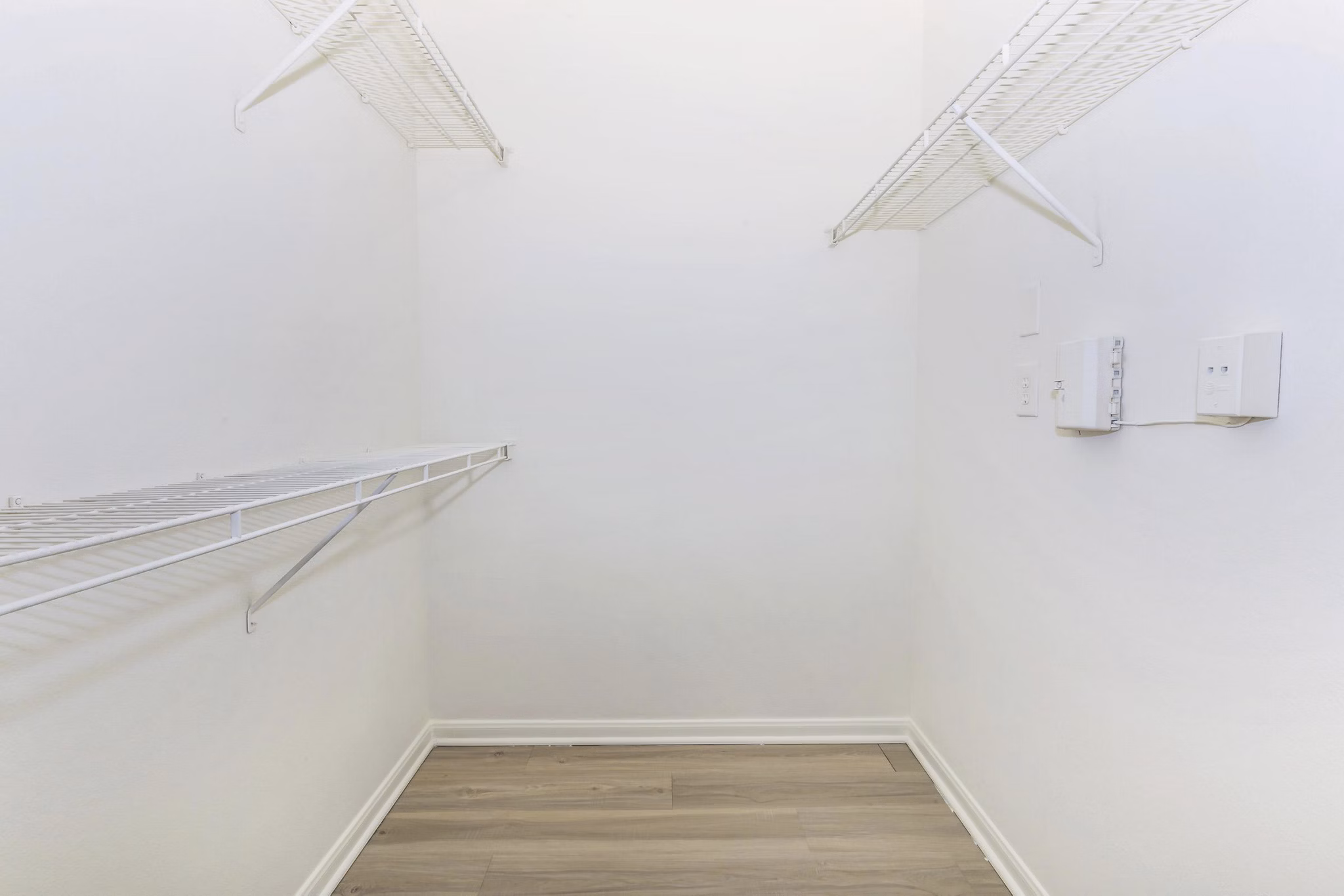 Walk-in closet with ample shelving at The Heights Apartments City Park