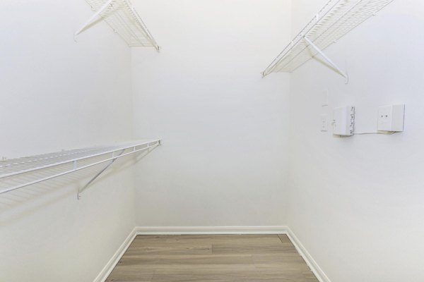 Walk-in closet with ample shelving at The Heights Apartments City Park