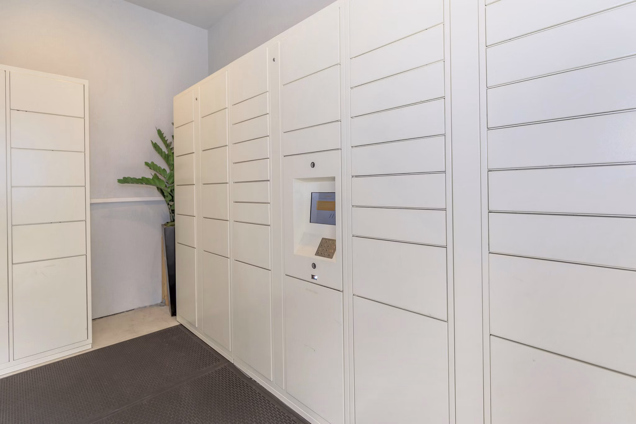 Mail room with parcel lockers in The Heights Apartments at City Park