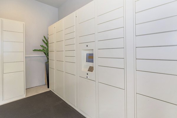 Mail room with parcel lockers in The Heights Apartments at City Park