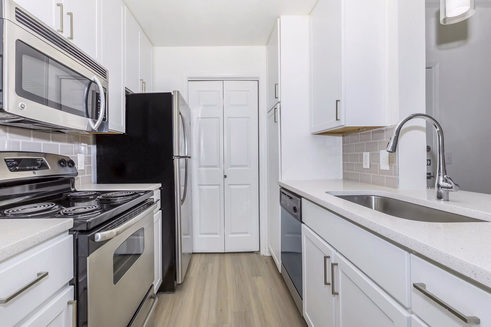 Modern kitchen with stainless steel appliances at City Park in The Heights Apartments