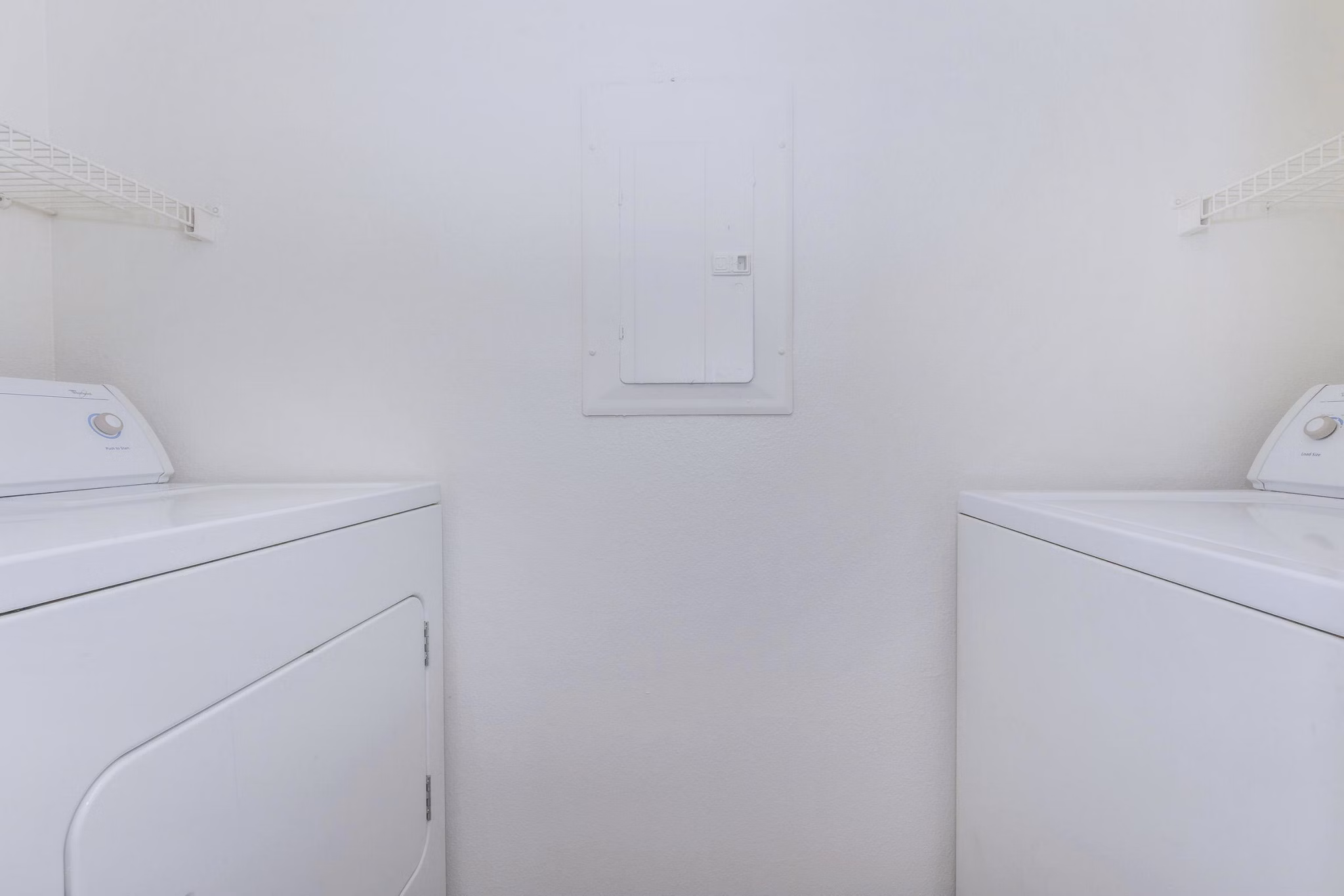 Laundry room with energy-efficient washers and dryers at City Park in The Heights Apartments