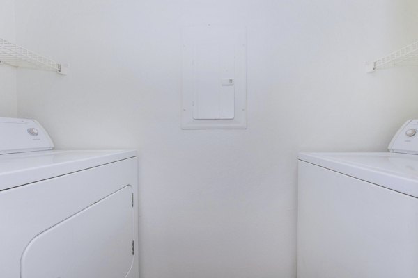 Laundry room with energy-efficient washers and dryers at City Park in The Heights Apartments