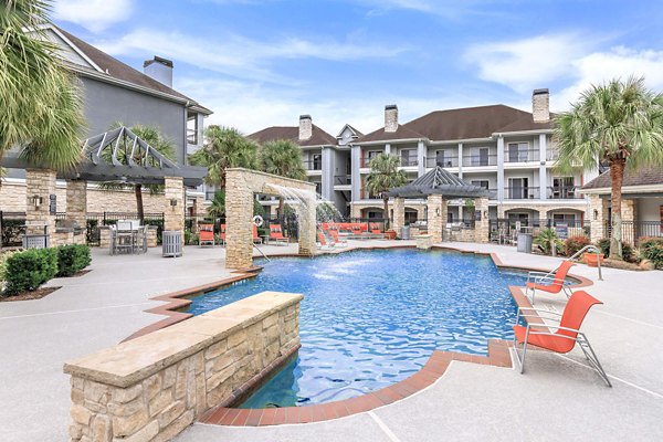 Luxurious pool with sun loungers at City Park in The Heights Apartments