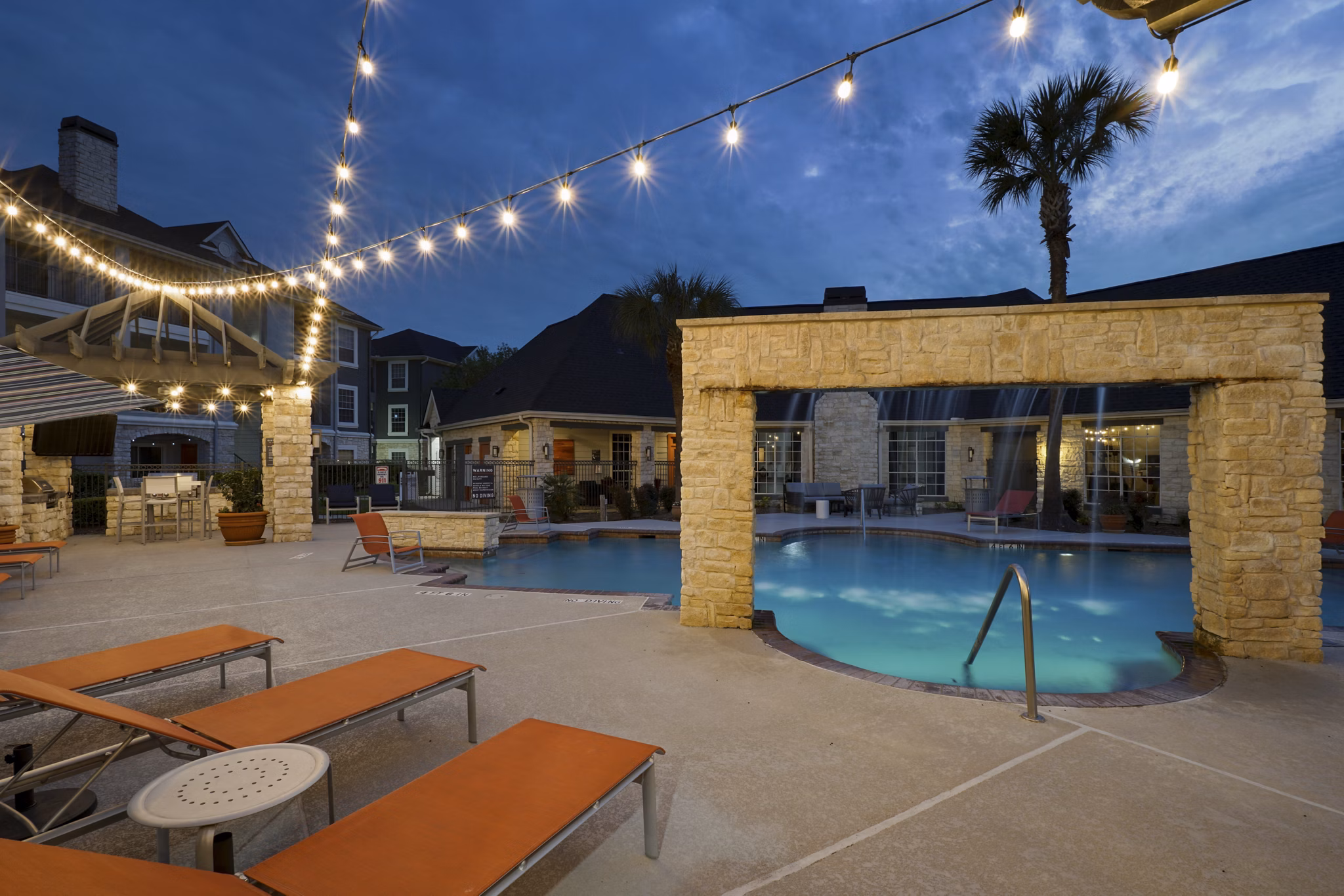 Resort-style pool with sun loungers at The Heights Apartments in City Park, perfect for relaxation and leisure