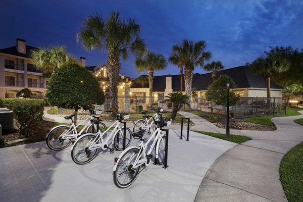 Courtyard featuring lush greenery and modern seating at City Park in The Heights Apartments, offering a serene outdoor community space