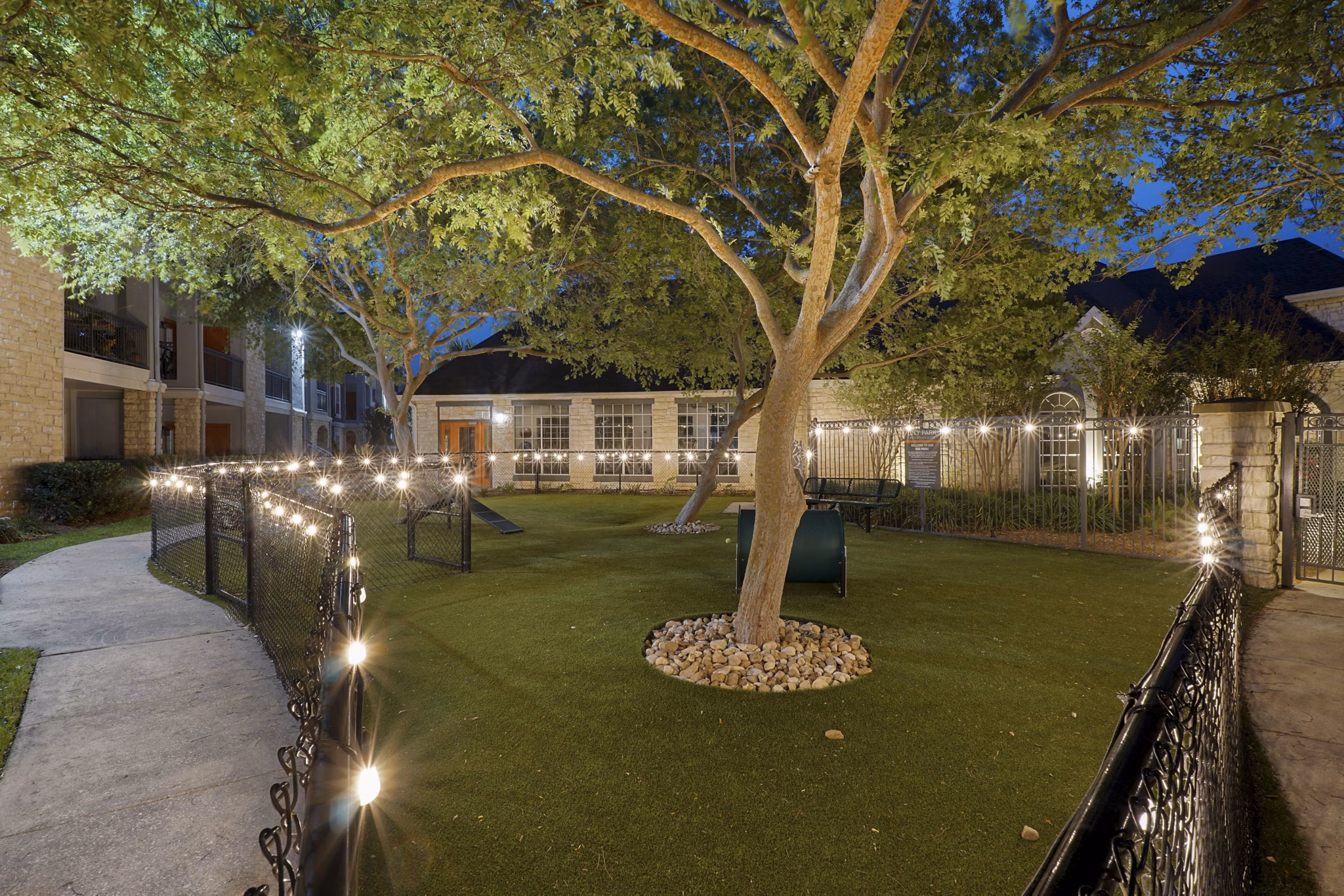 Spacious dog park with lush greenery at The Heights Apartments' City Park