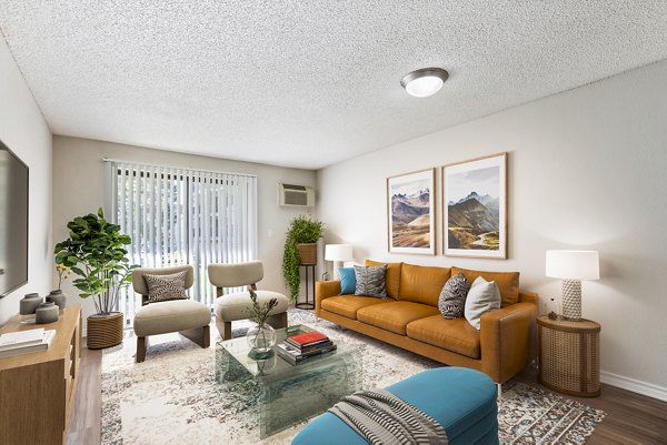 Spacious living room with modern decor and ample natural light at Belmar Villas Apartments