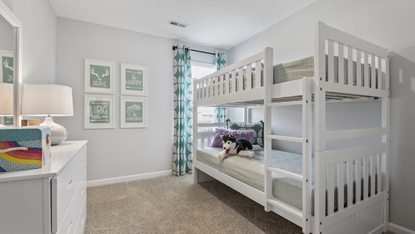 Bedroom featuring elegant decor and plush bedding in Rosemary Glen Apartments