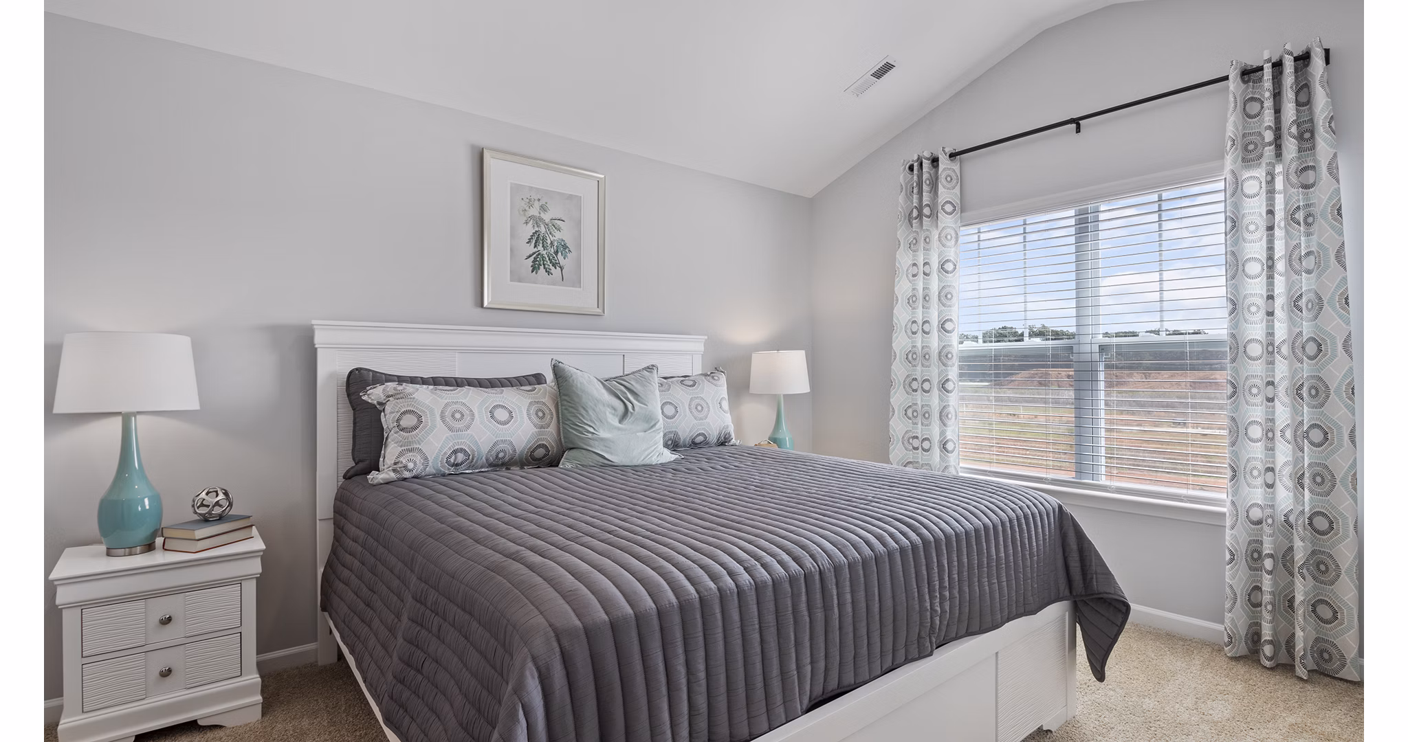Bedroom at Rosemary Glen Apartments: Cozy bedroom with modern furnishings and natural lighting