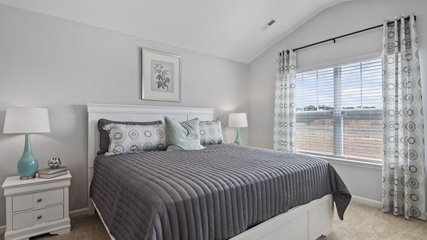 Bedroom at Rosemary Glen Apartments: Cozy bedroom with modern furnishings and natural lighting