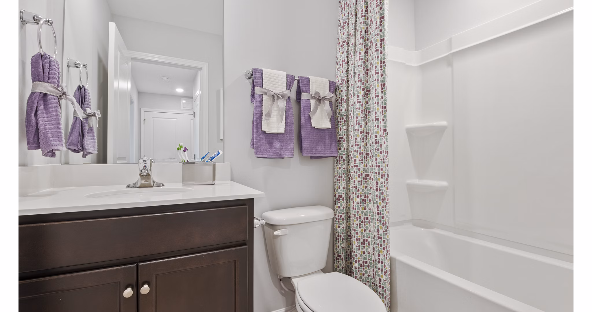 Elegant bathroom with marble countertops in Rosemary Glen Apartments