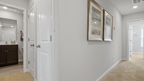 Hallway with contemporary lighting and artwork at Rosemary Glen Apartments, luxury apartments by Greystar