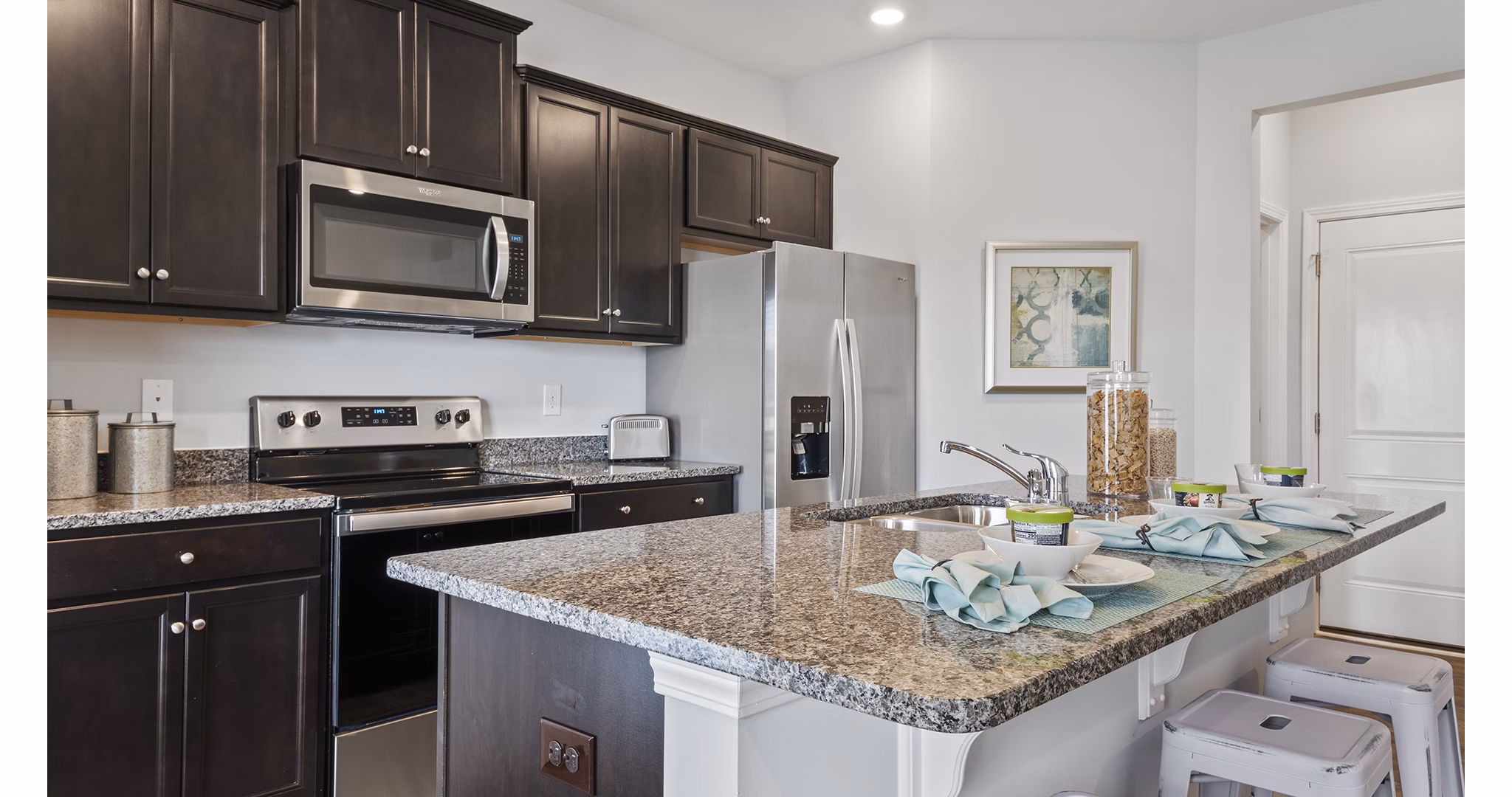Modern kitchen with stainless steel appliances at Rosemary Glen Apartments
