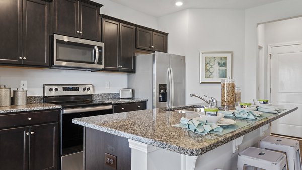 Modern kitchen with stainless steel appliances at Rosemary Glen Apartments