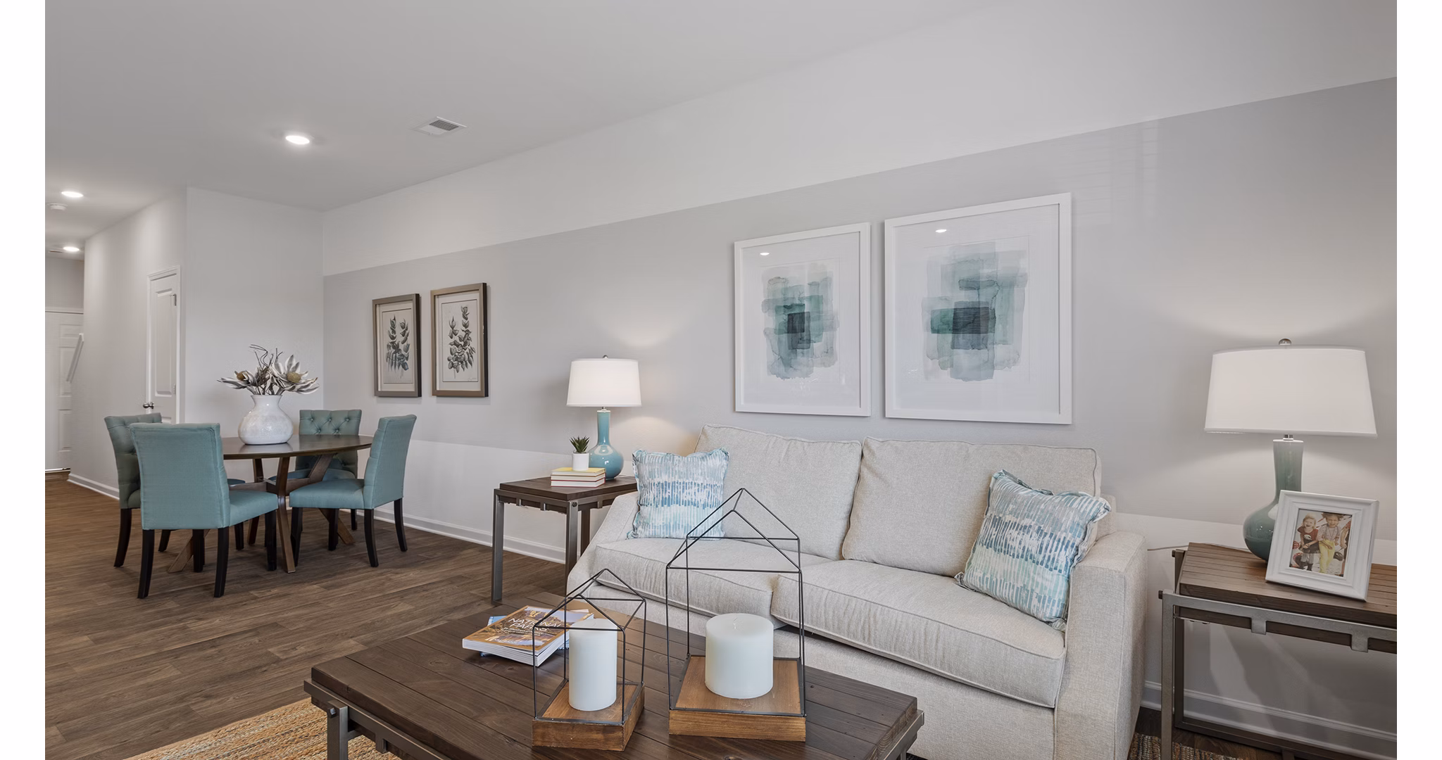 Modern living room featuring plush seating and large windows at Rosemary Glen Apartments