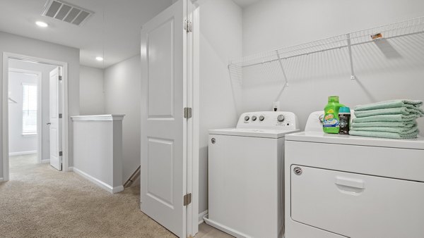 Laundry room equipped with modern washers and dryers in Rosemary Glen Apartments