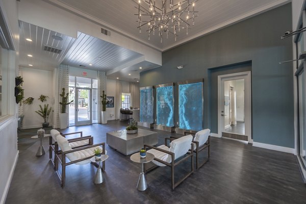 Modern clubhouse with indoor seating and entertainment area at Cyan at Green Valley Apartments