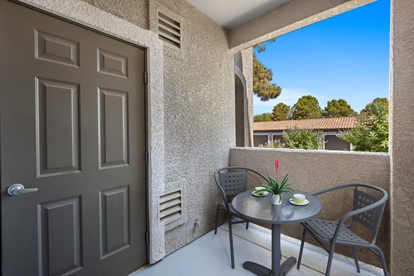 Cozy patio with modern seating at Cyan at Green Valley Apartments, perfect for relaxing or entertaining with scenic views