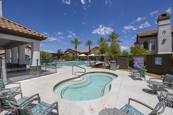 Relaxing hot tub at Cyan at Green Valley Apartments offering a serene escape with ambient lighting and garden views