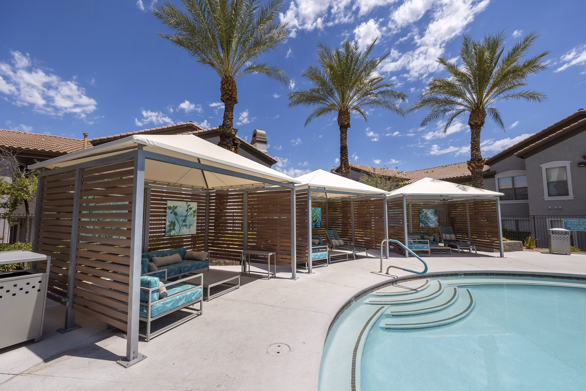 â€œResort-style pool with lounge seating at Cyan at Green Valley Apartmentsâ€