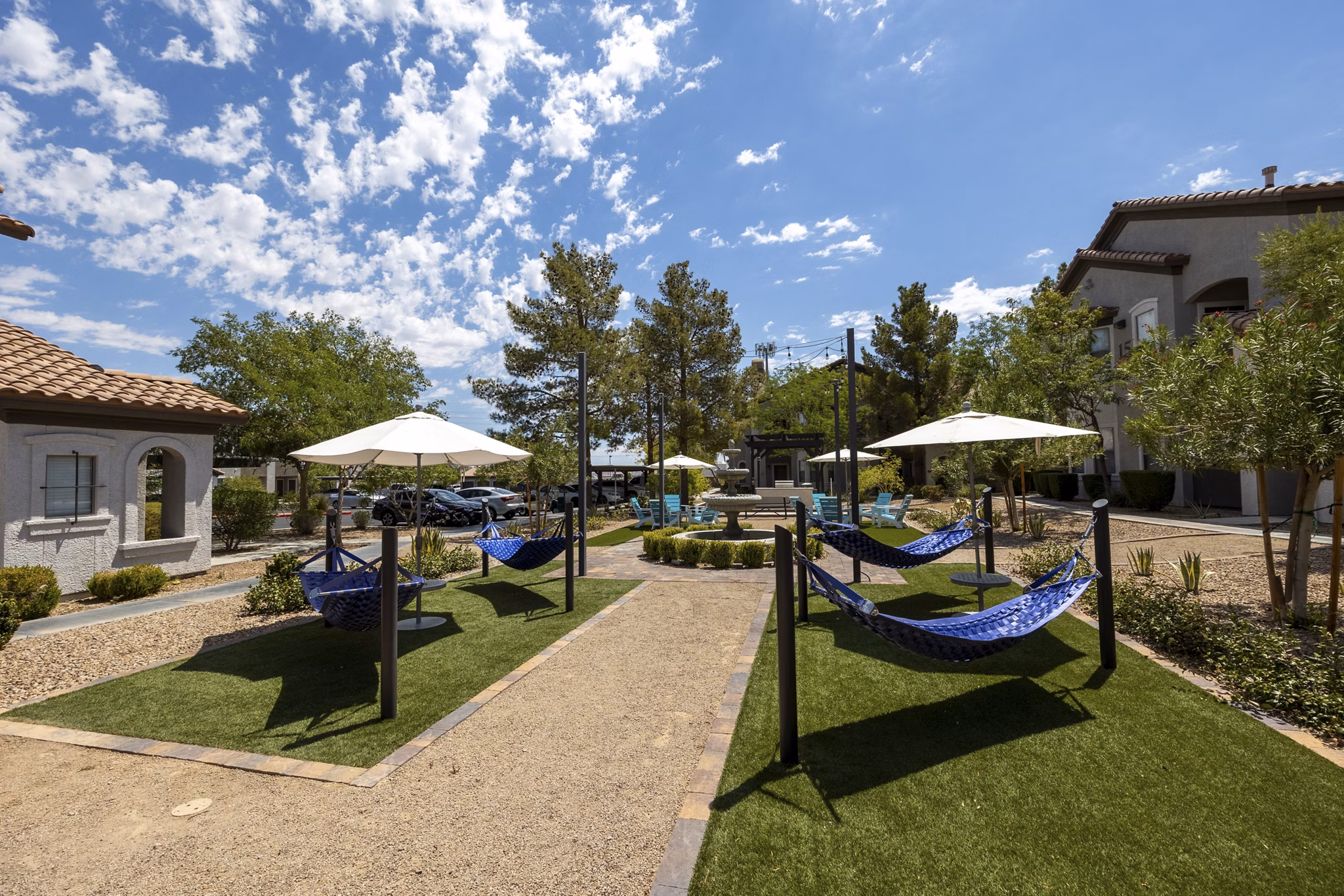 Courtyard with lush landscaping and seating areas at Milano Apartments
