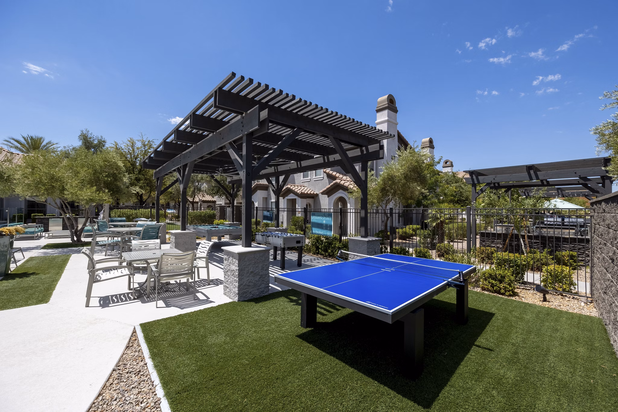 Courtyard with lush landscaping and modern seating at Milano Apartments, a luxury property in the heart of the city