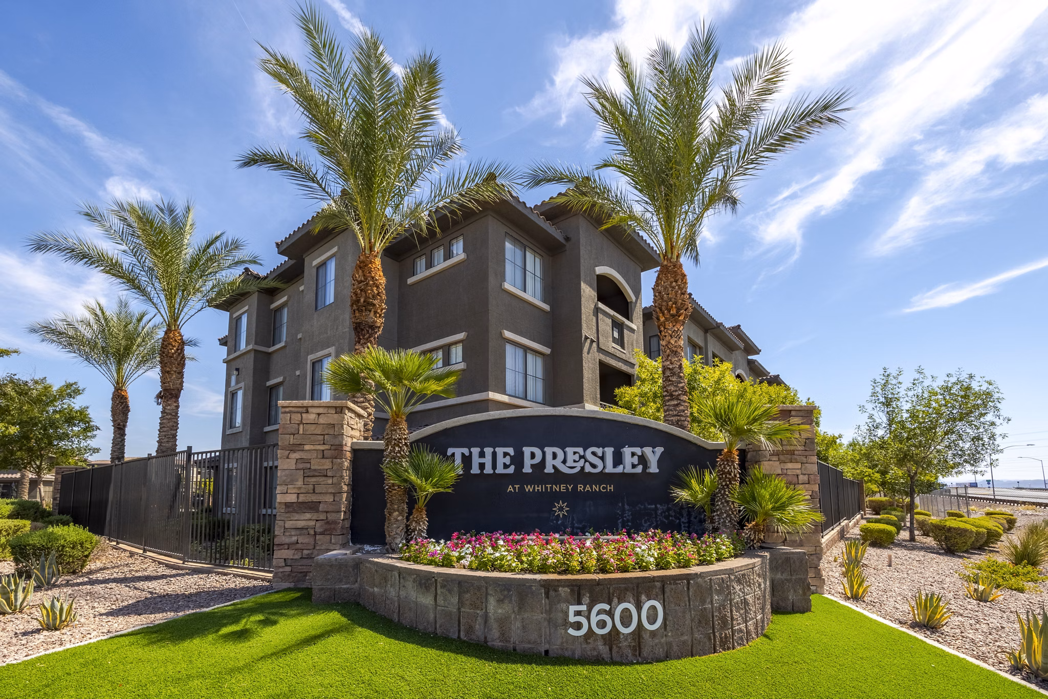 The Presley: Elegant building with distinctive signage at Whitney Ranch apartments