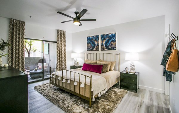 The Presley at Whitney Ranch Apartments: Modern bedroom with plush bedding and stylish decor