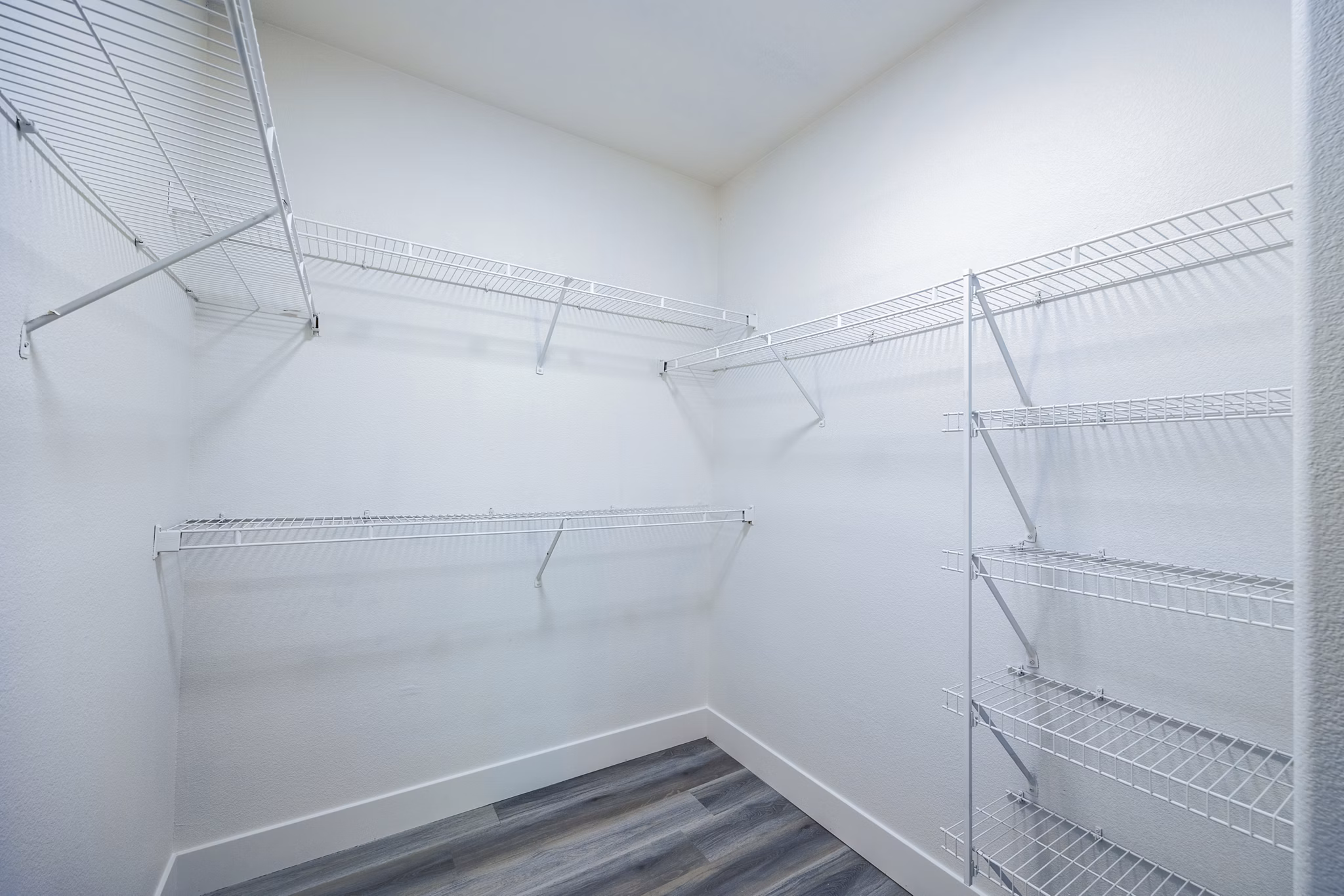 Spacious bedroom closet with custom shelving at The Presley at Whitney Ranch Apartments