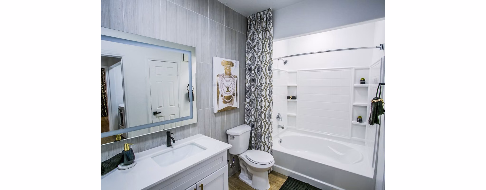 Luxurious bathroom featuring marble countertops and modern fixtures at The Presley at Whitney Ranch Apartments