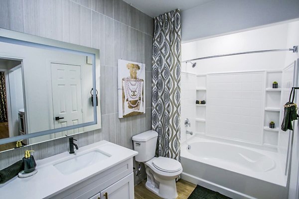 Luxurious bathroom featuring marble countertops and modern fixtures at The Presley at Whitney Ranch Apartments