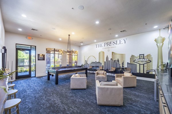 Clubhouse game room featuring pool table and lounge seating at The Presley at Whitney Ranch Apartments, a Greystar luxury property