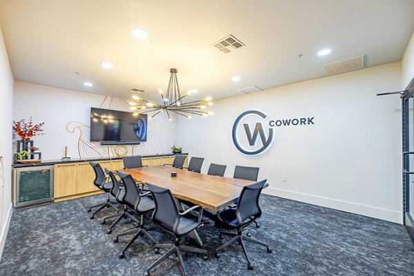 Clubhouse meeting facility with modern seating and tech amenities at The Presley at Whitney Ranch Apartments