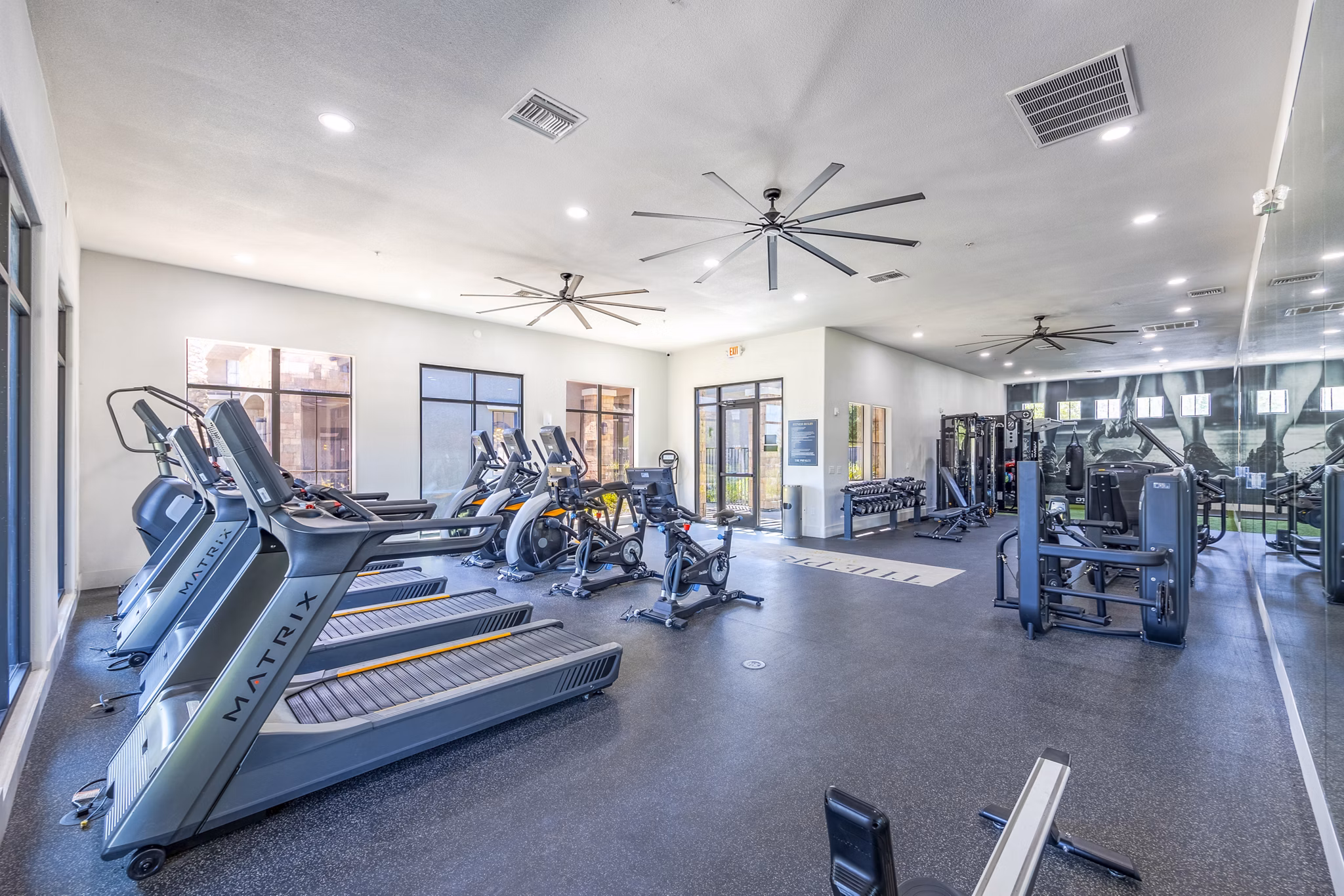 State-of-the-art fitness center with cardio machines at The Presley at Whitney Ranch Apartments