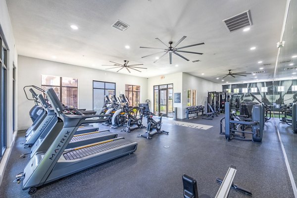 State-of-the-art fitness center with cardio machines at The Presley at Whitney Ranch Apartments