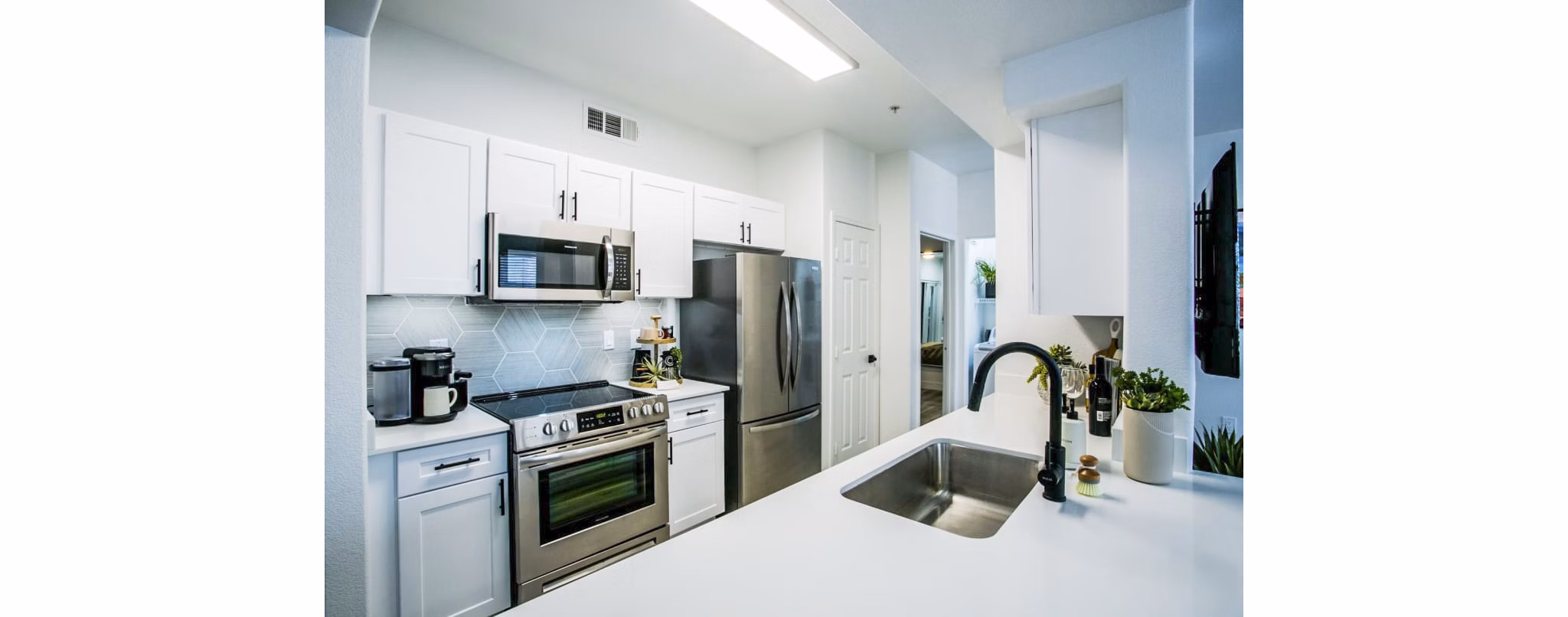 Modern kitchen with sleek appliances at The Presley luxury apartments in Whitney Ranch Homes
