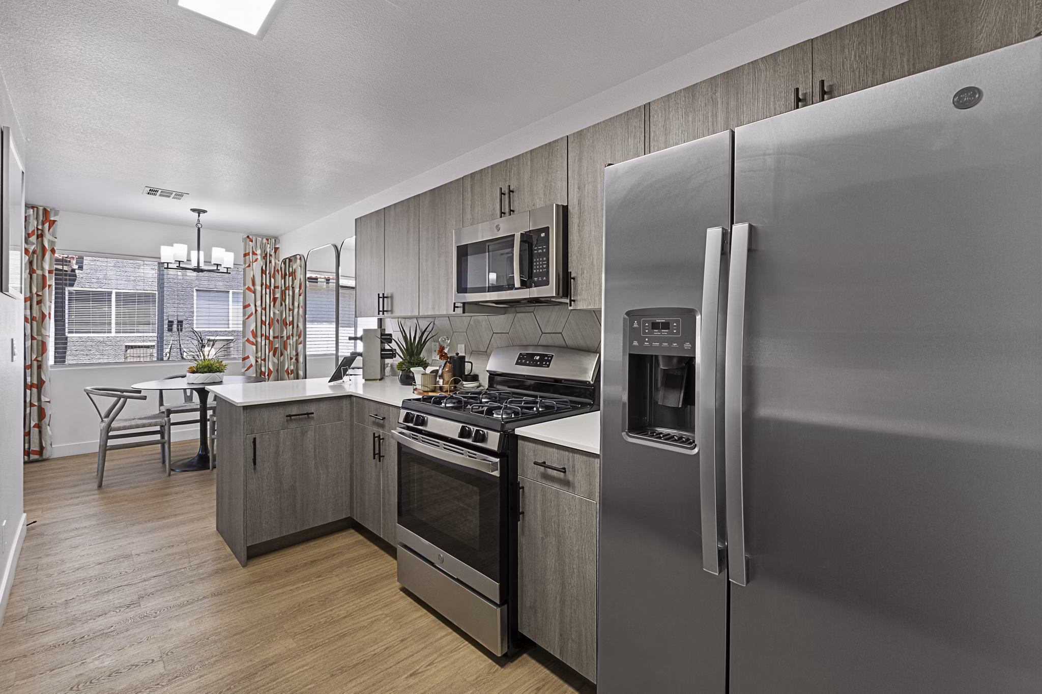 Kitchen featuring modern appliances and granite countertops in Townhomes at Horizon Ridge Apartments