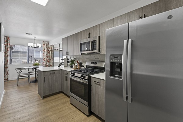 Kitchen featuring modern appliances and granite countertops in Townhomes at Horizon Ridge Apartments