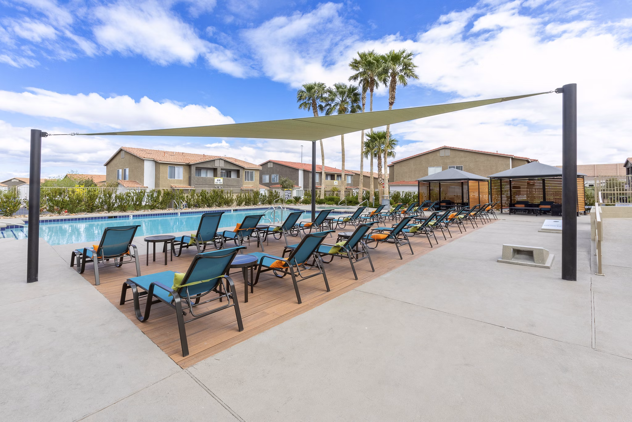 Resort-style pool at Townhomes at Horizon Ridge featuring sun loungers and landscaped grounds
