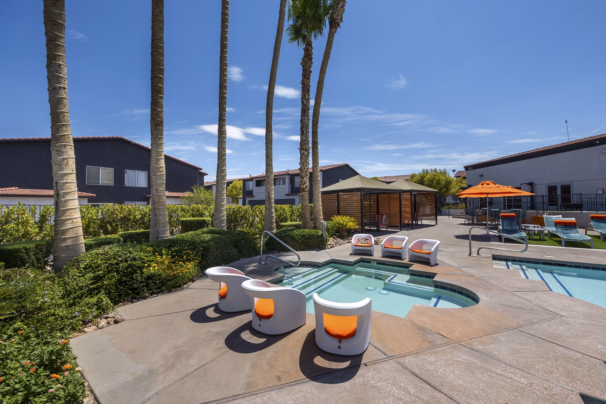 Resort-style pool with lounge chairs at Townhomes at Horizon Ridge Apartments