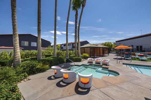 Resort-style pool with lounge chairs at Townhomes at Horizon Ridge Apartments