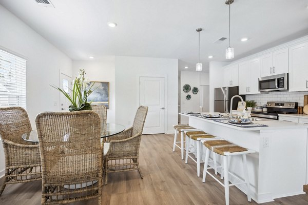 Dining room featuring elegant chandelier and hardwood floors at River Rock at Blume Road Apartment Homes