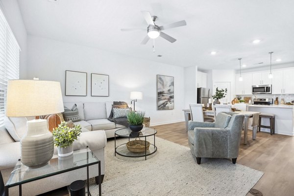 Bright living room with modern decor at River Rock at Blume Road Apartment Homes