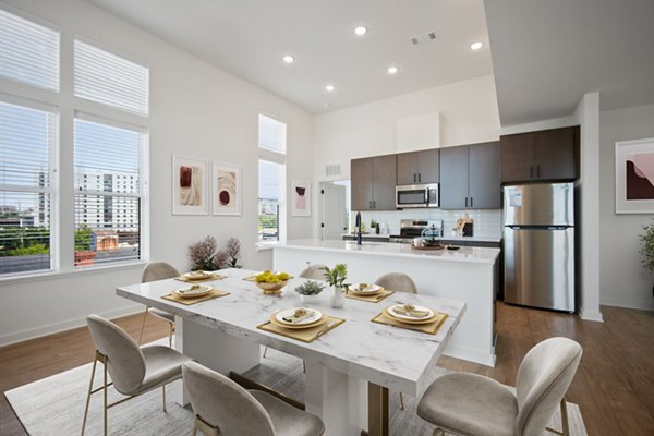 Dining room with modern decor and ample seating in The Navigator Apartments