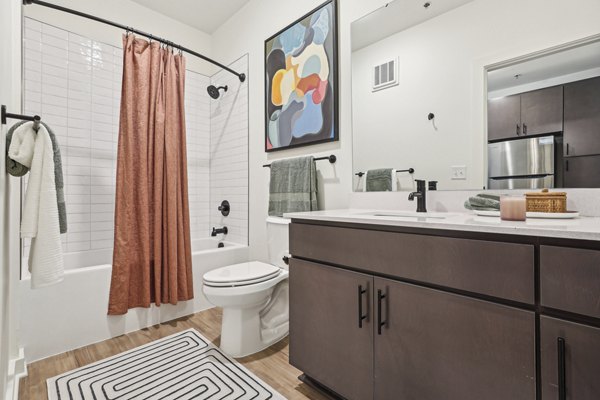 Luxurious bathroom featuring marble countertops and modern fixtures in The Navigator Apartments